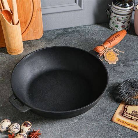 Detail drevenej rukoväte liatinovej panvice