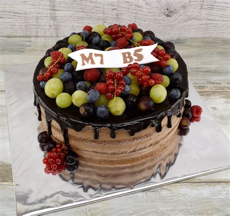 Nahá svadobná torta zdobená ovocím a bielymi krajkami