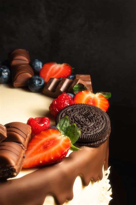 Detail zdobenia čokoládovej torty čerstvým ovocím a hoblinkami čokolády